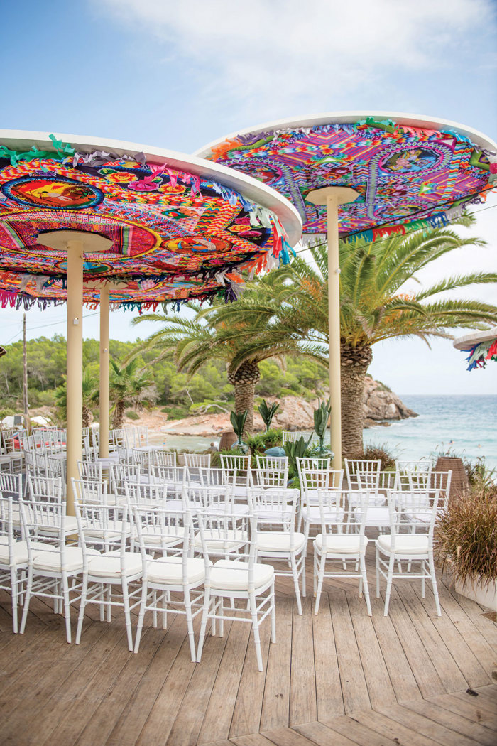 A group of chairs under colourful umbrellas at Aiyanna Ibiza