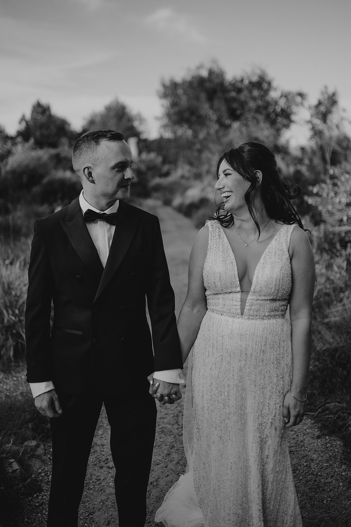 Bride and groom holding hands during black and white portrait at Boschendal Wine Estate, Cape Town, South Africa destination wedding
