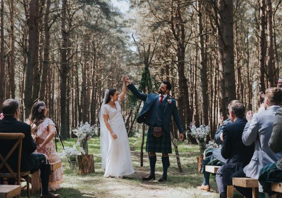 couple cheer after tying the knot in outdoor ceremony at harvest moon in dunbar
