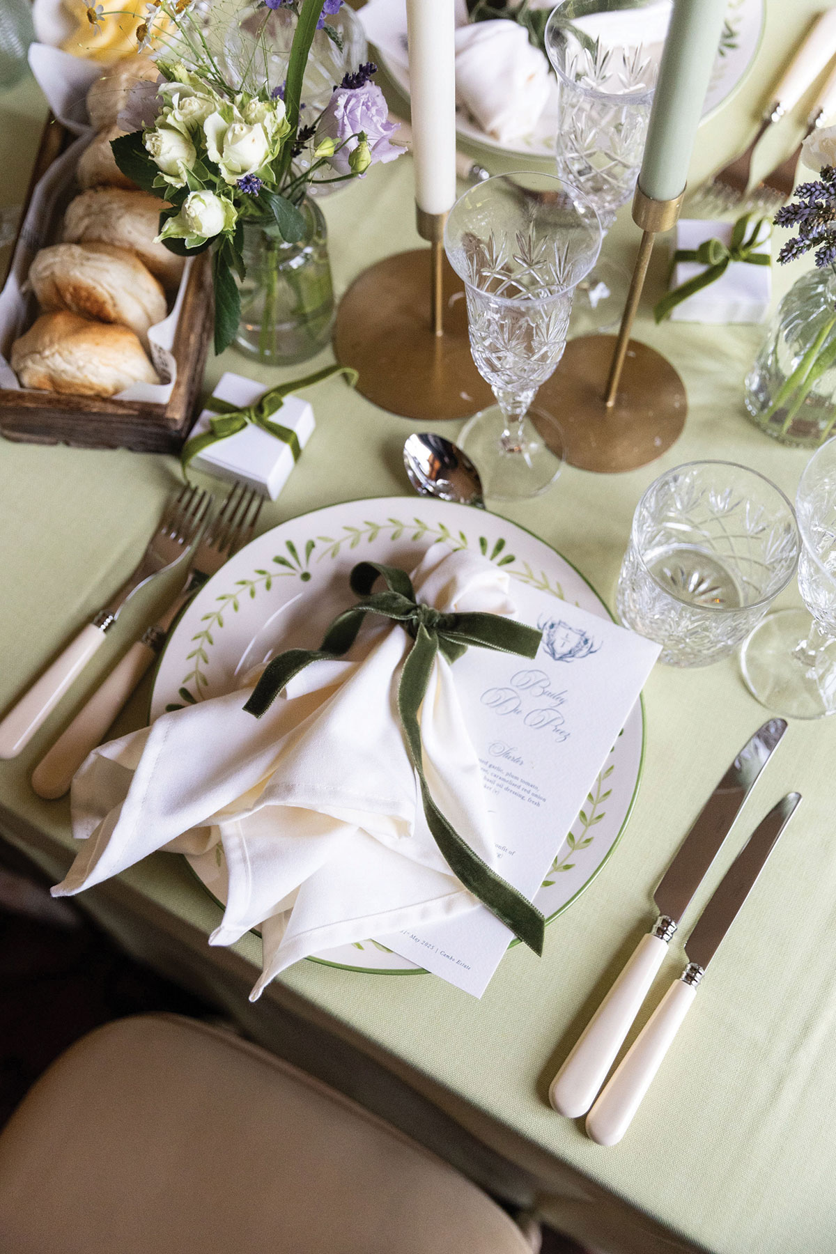 Bride and stylist holding an Opus Couture wedding dress garment bag inside a Scottish bridal boutique.