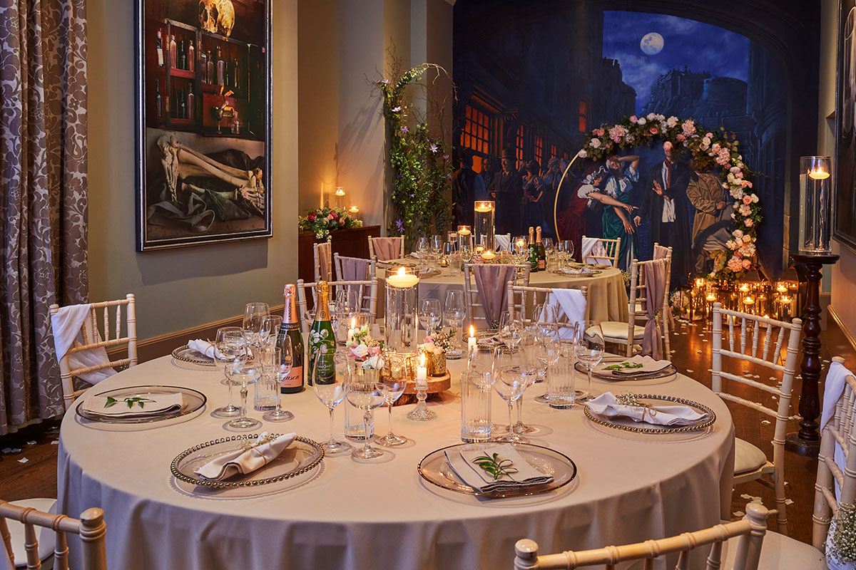 Elegant wedding breakfast setup in the Burke & Hare room at Hotel du Vin Edinburgh with candles and floral décor