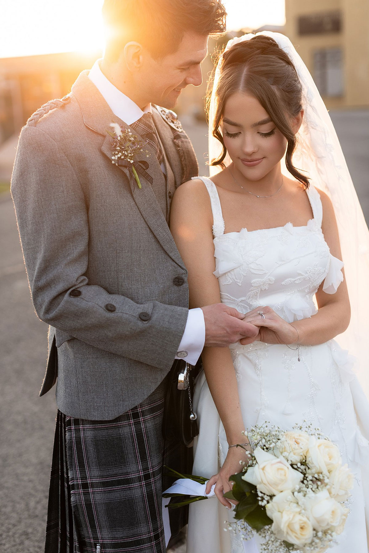 Bride and groom embracing during sunset portraits outside Old Course Hotel in St Andrews on their wedding day.