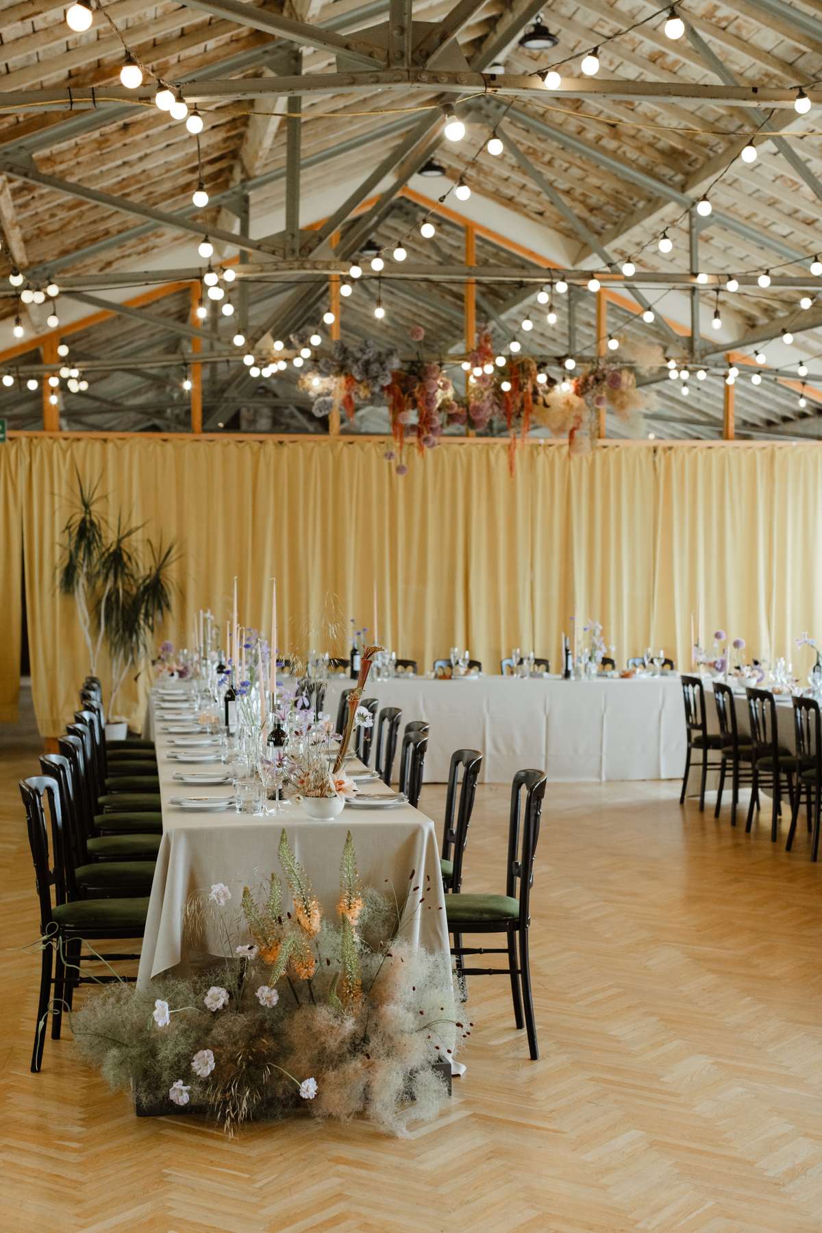 Colourful Civic House wedding reception with floral installations and long tables