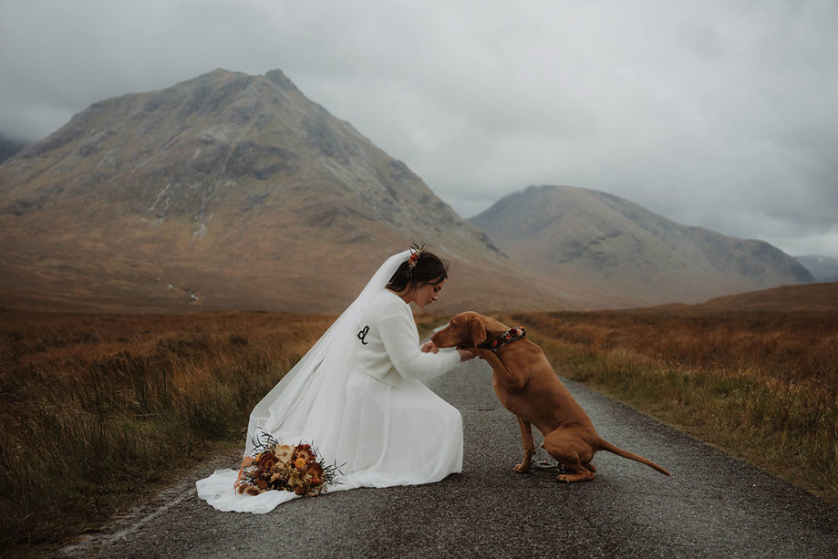 a bride with a dog and Glencoe mountains in the background