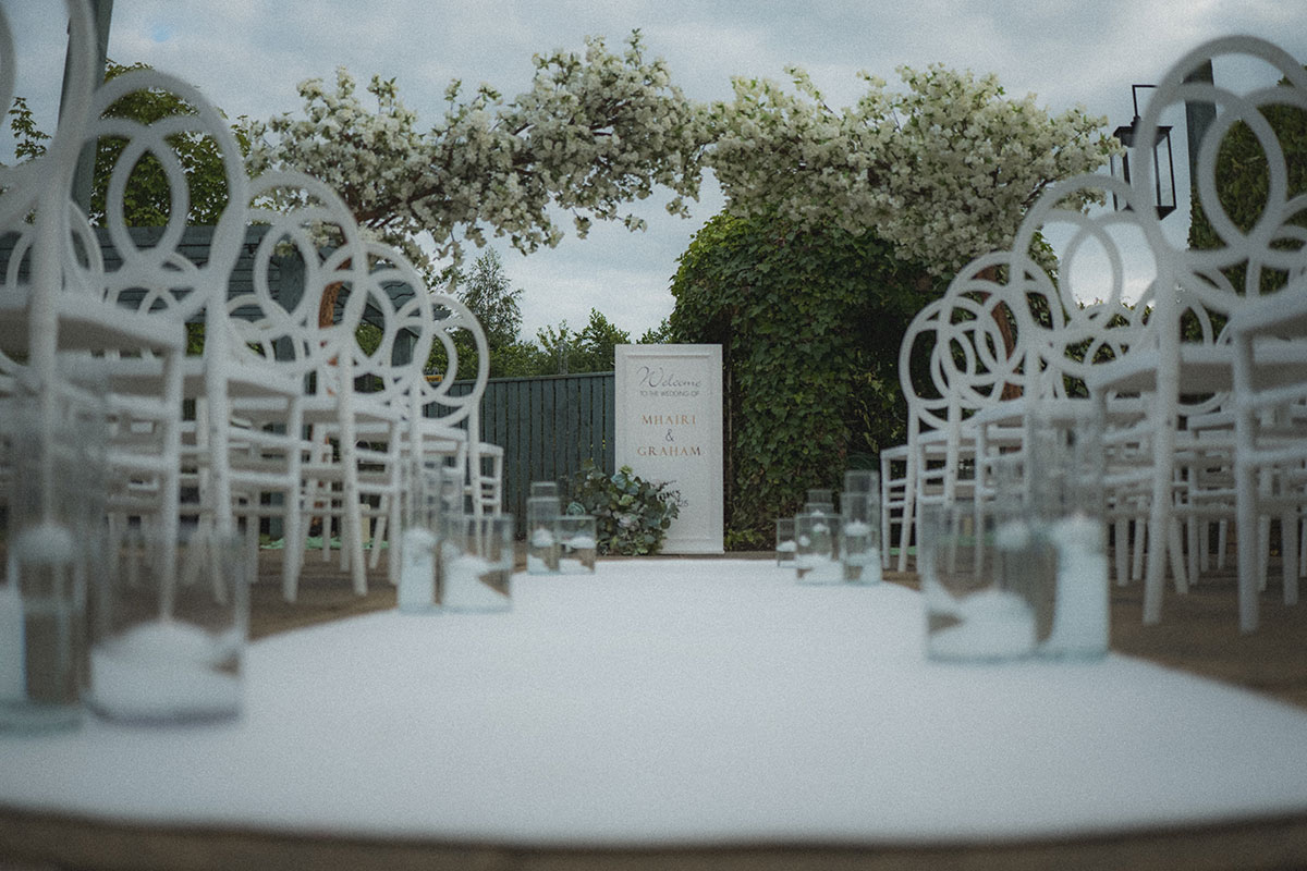 ceremony set up for a wedding at the river inn with white detailed chairs