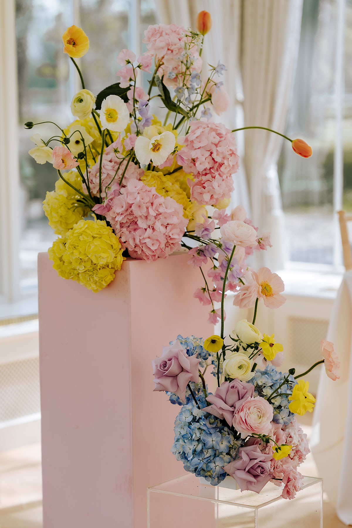 arrangements of colourful pastel wedding flowers at Carlowrie Castle wedding ceremony
