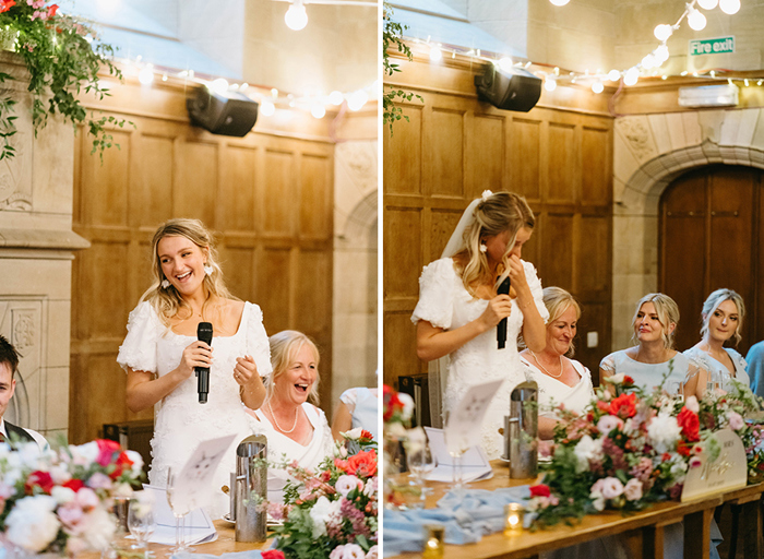 A bride holding a microphone and giving a speech next to people who are sitting down