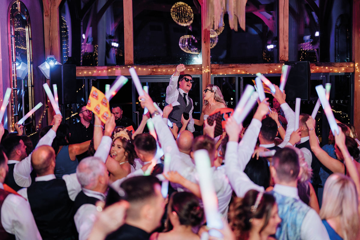 Couple and guests on wedding day on the dance floor
