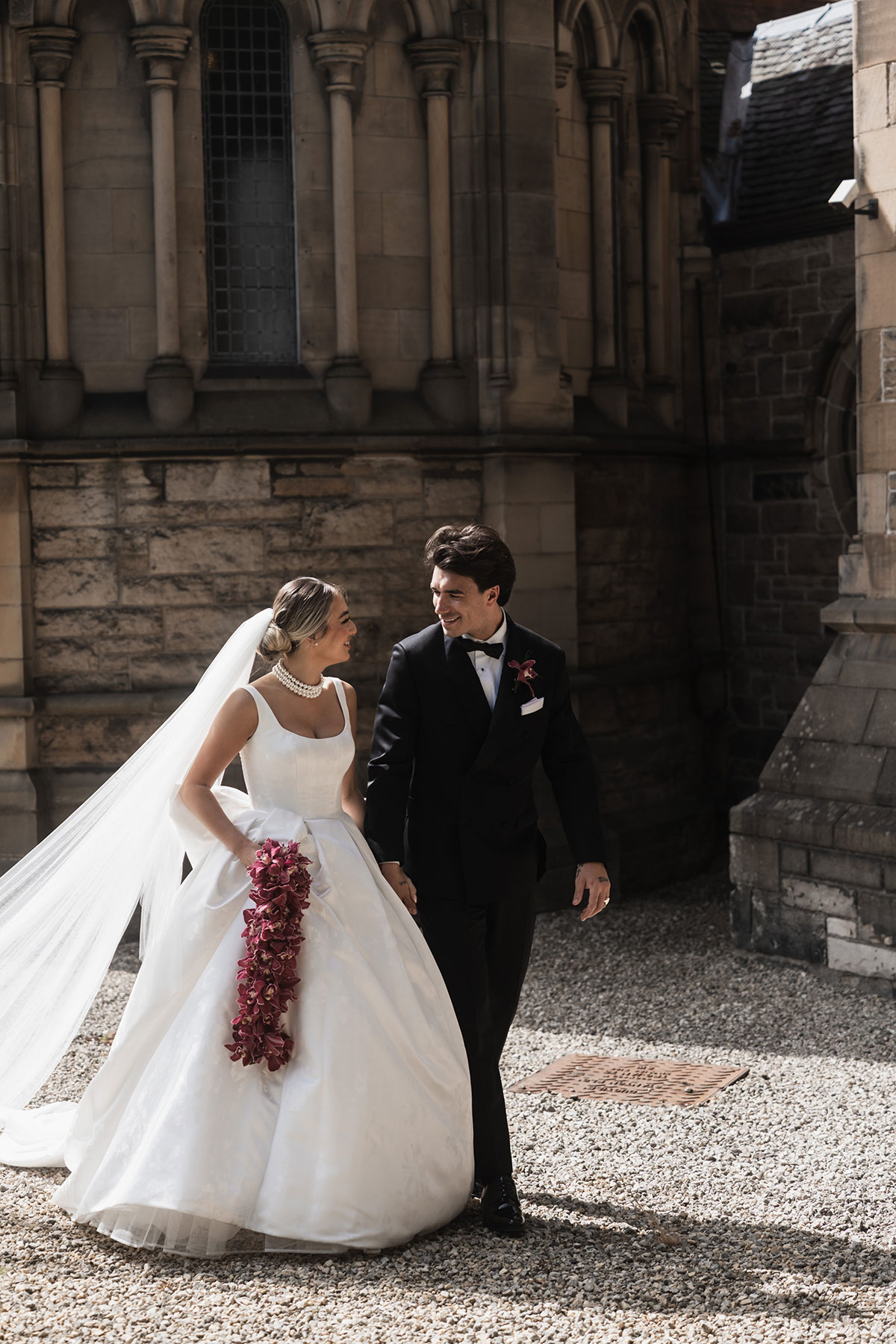Bride and groom walking together outside Mansfield Traquair in Edinburgh after their ceremony