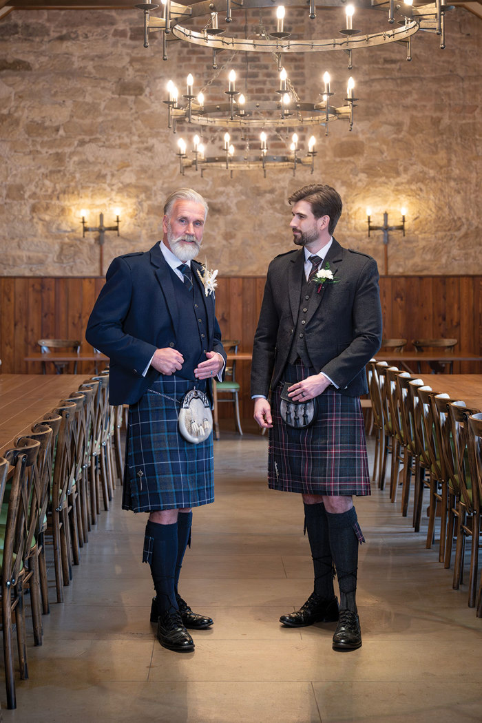 two men wearing kilt outfits from Clan Kilts standing in The Threshing Barn at Rosebery Steading