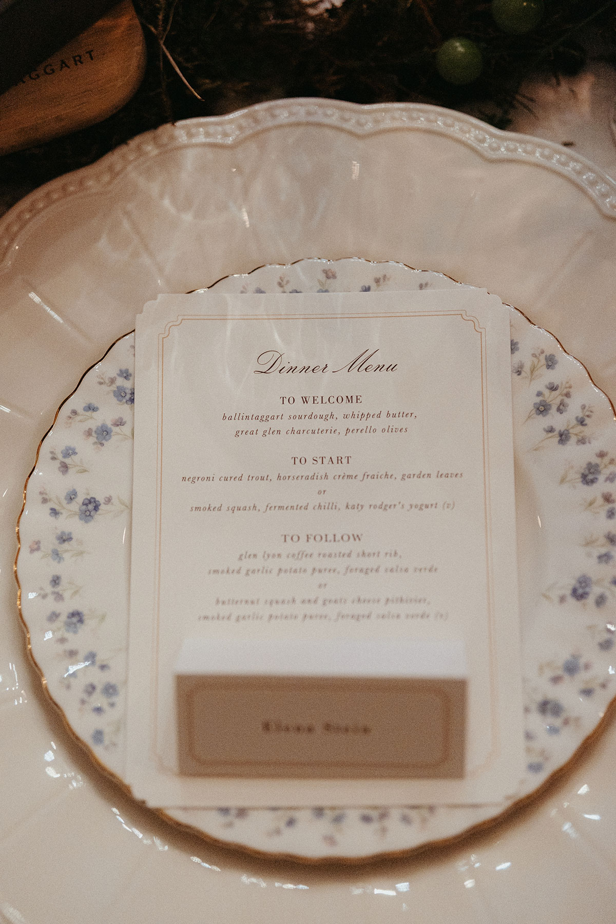 Elegant wedding place setting featuring a printed dinner menu, personalised name card and vintage floral china at Cambo Country House.