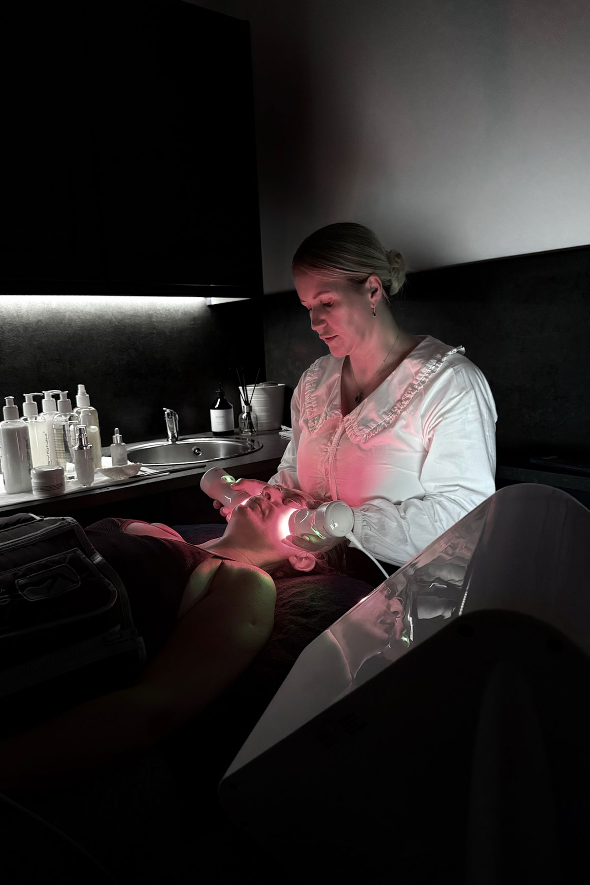Byonik Laser Facial in progress at FAB Salons, using LED wands to rejuvenate the skin