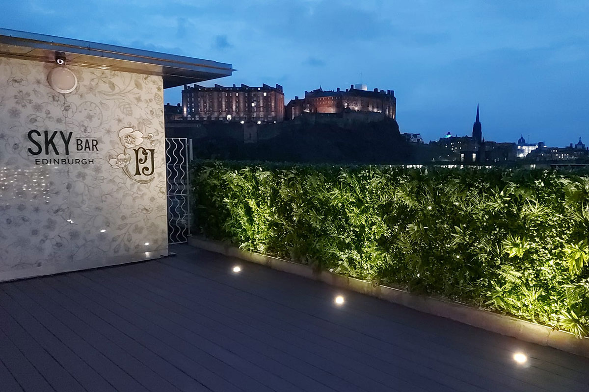 SKYBar Edinburgh rooftop terrace at night with views of Edinburgh Castle and city skyline