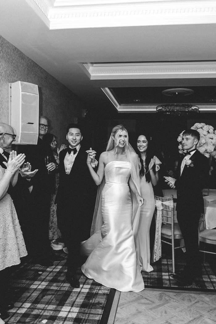 a bride and groom entering evening wedding reception at busby hotel