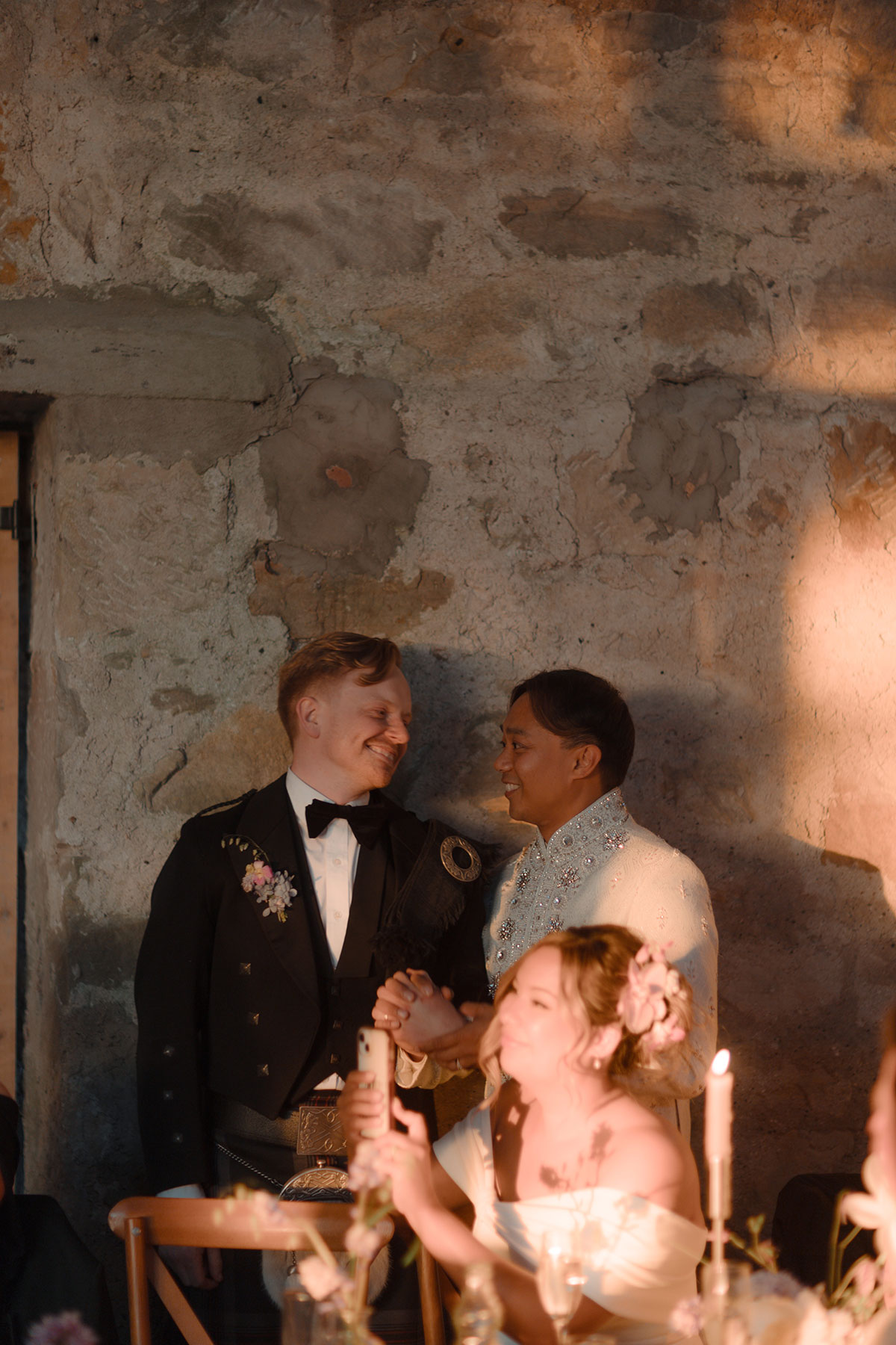 Emotional reactions as grooms watch surprise choir performance during Falkirk barn wedding reception