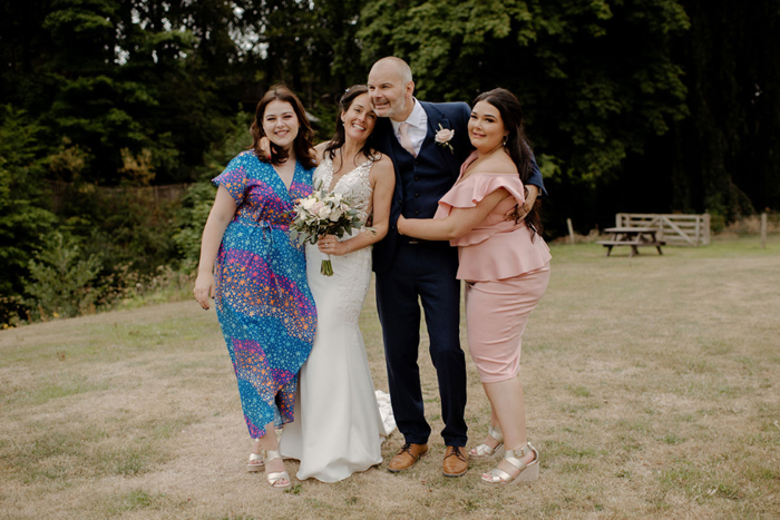 Family portrait of bride and groom with bride's two daughters