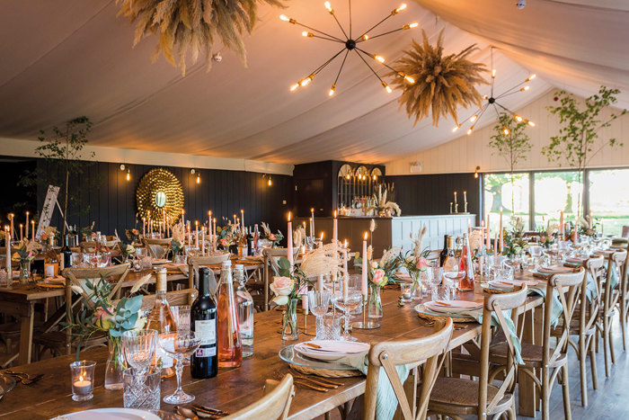 A table set for a wedding party in the wedding marquee at Dunglass Estate.