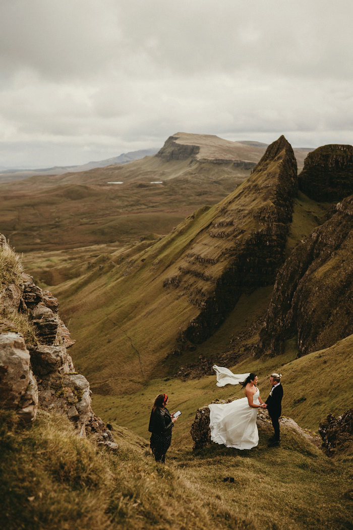 bride and groom kiss on top of The Quiraing on the Isle of Skye after humanist ceremony