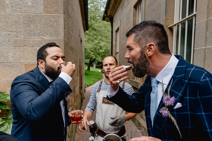 Grooms eat oysters during wedding ceremony