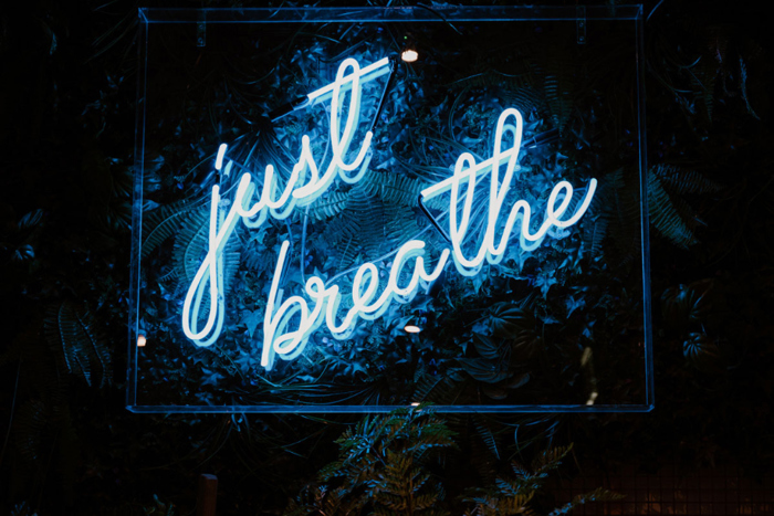 Neon sign reading Just Breathe