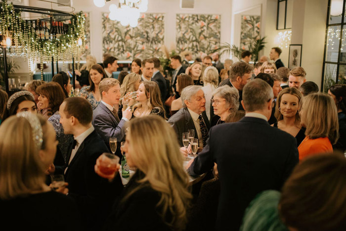 A crowd of people during a drinks reception