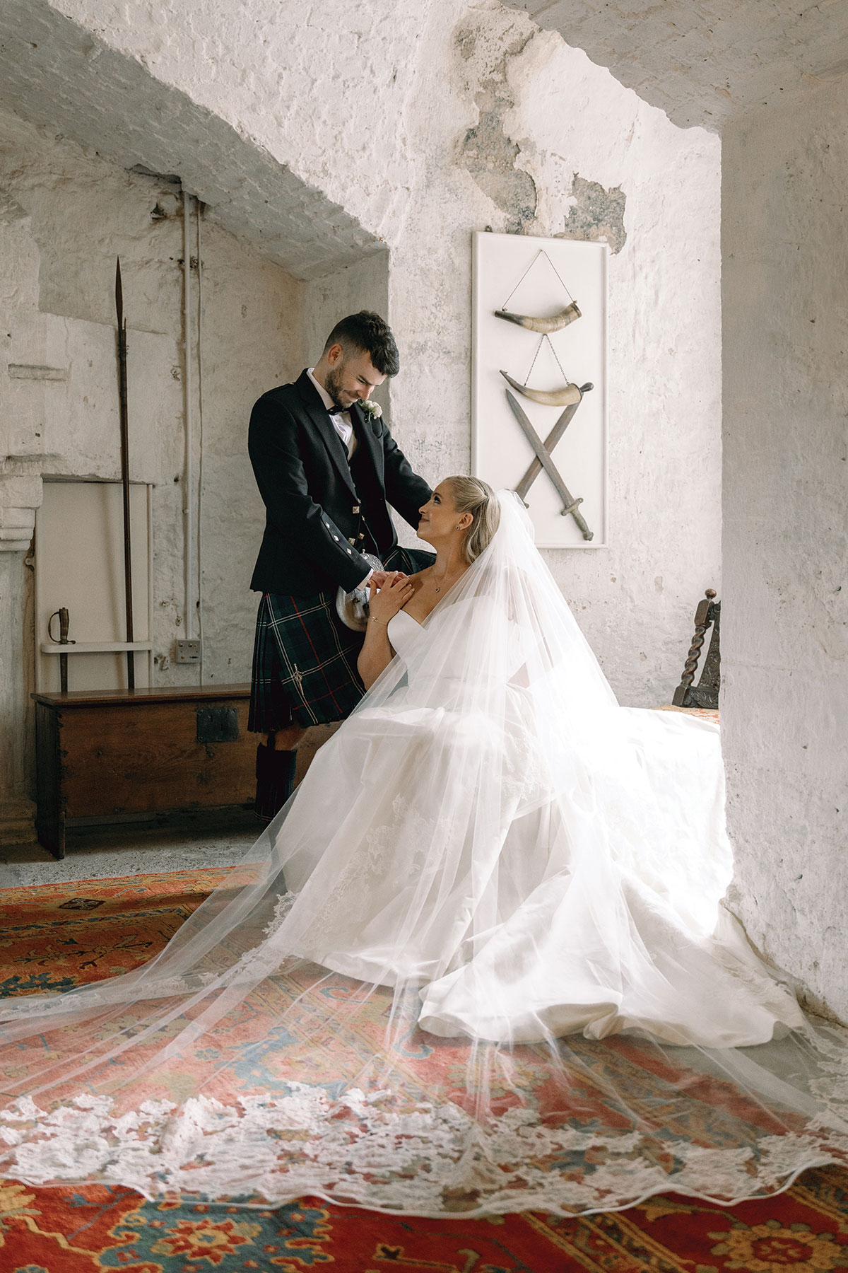 bride and groom smile at one another at dundas castle