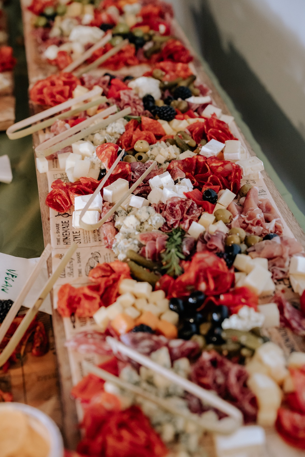 Wedding grazing table at Harvest Moon filled with cured meats, cheeses, olives, fruit and antipasti.
