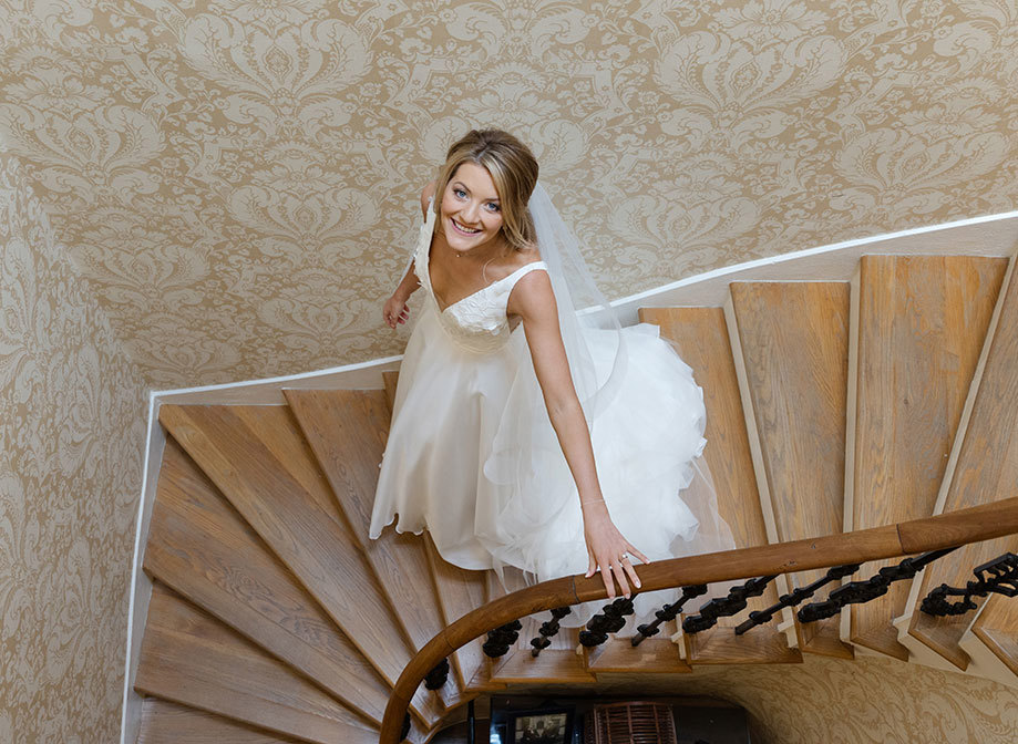 bride walking down stairs smiling