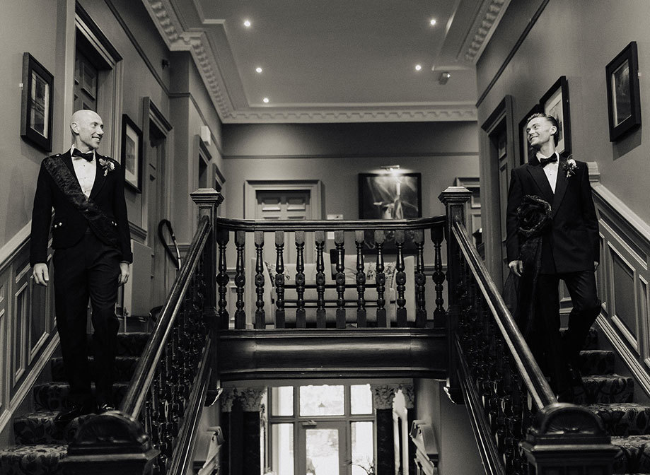 Black And White image of Grooms Going Downstairs 