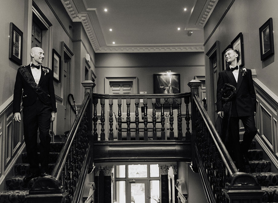 Black And White image of Grooms Going Downstairs