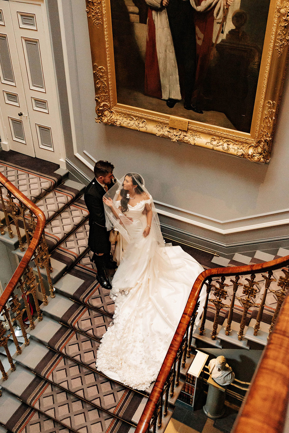 bride and groom on iconic staircase at signet library edinburgh