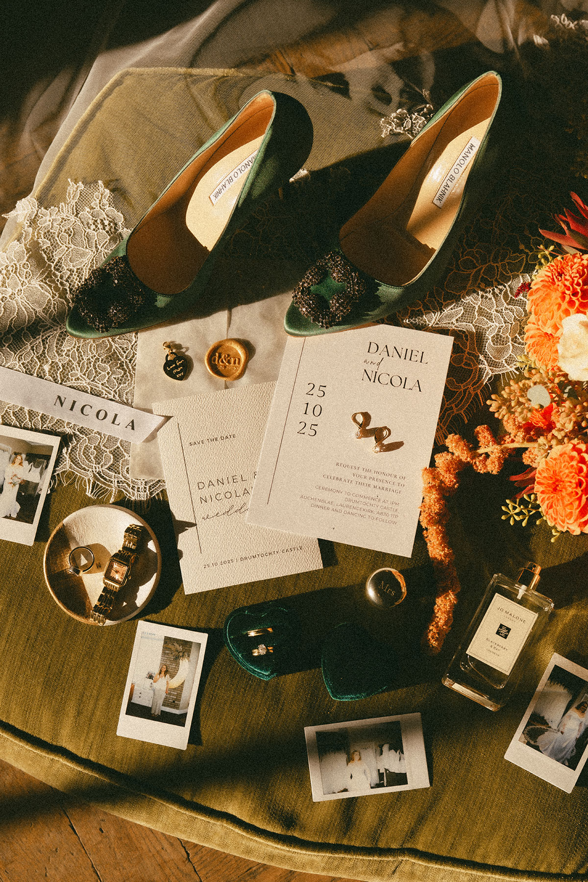 Luxury Scottish wedding details flat lay with green velvet bridal shoes, stationery, jewellery, perfume and autumnal florals