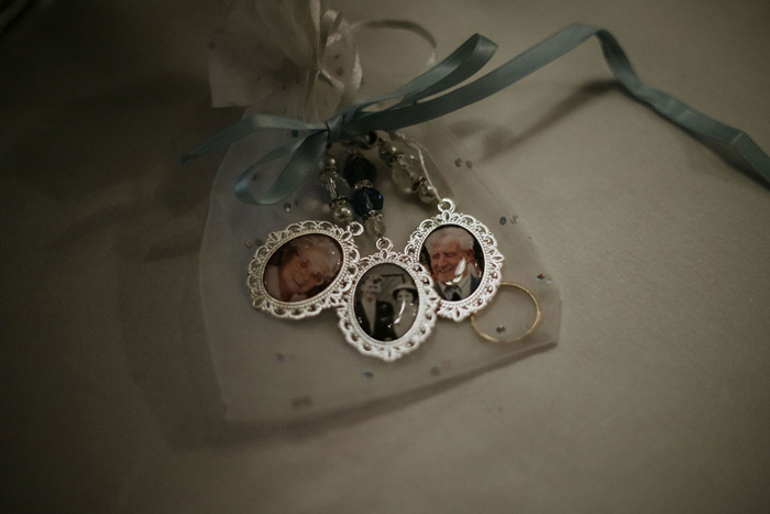 A Bouquet Charm Featuring Three Photos In Silver Frames