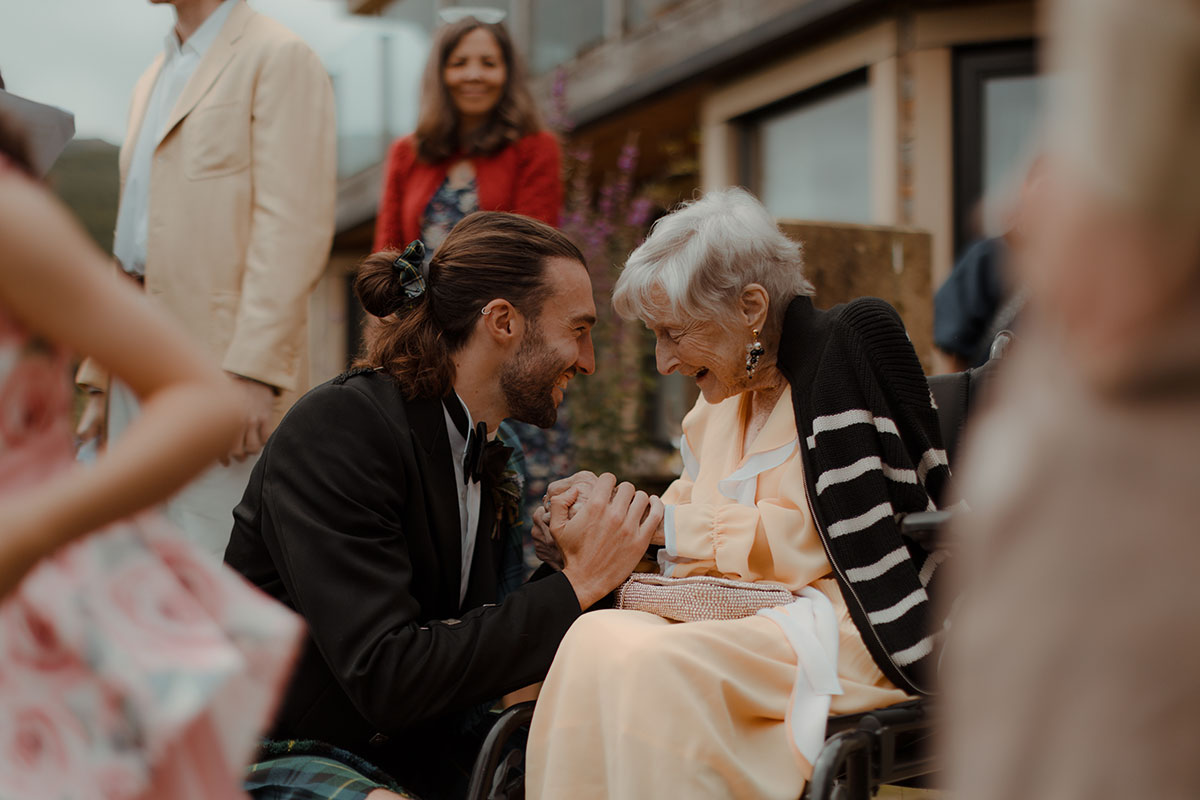 a groom with his grandmother outside the Lodge at Carrick Castle Esate