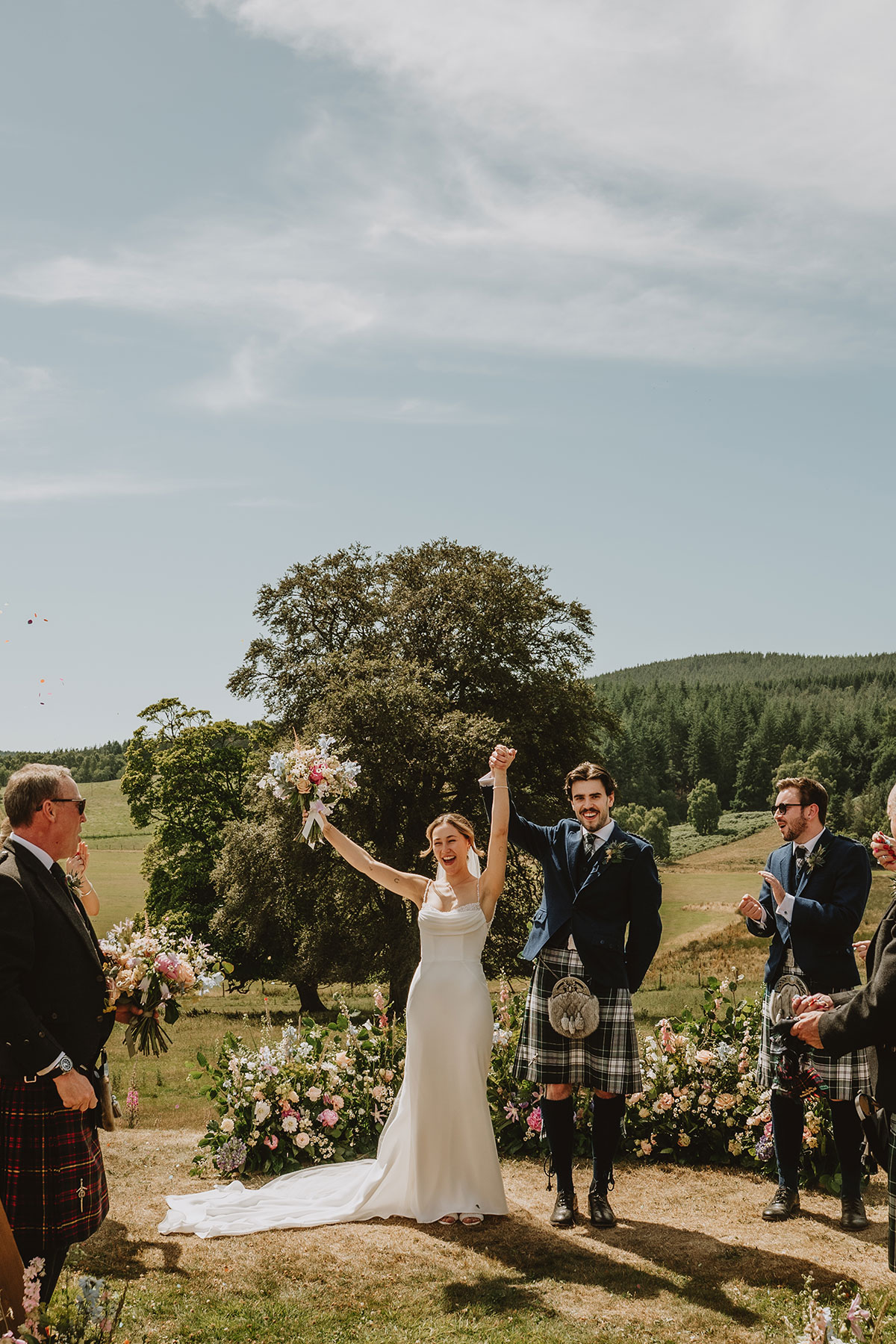 Couple standing on the lawn outside Ballogie House after their ceremony