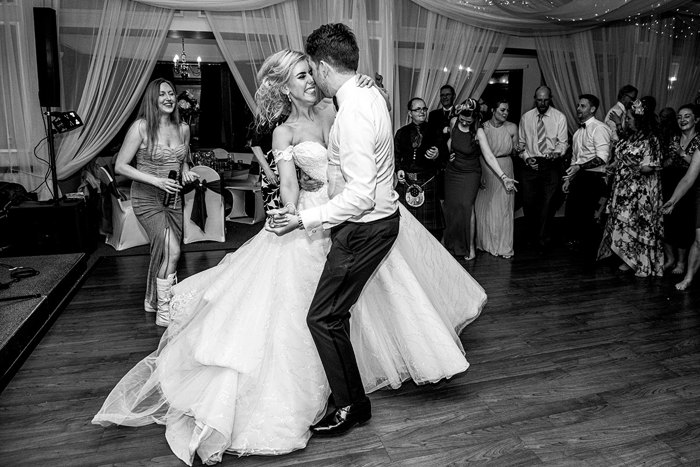 A Black And White Image Of A Bride And Groom Dancing At The Weigh Inn