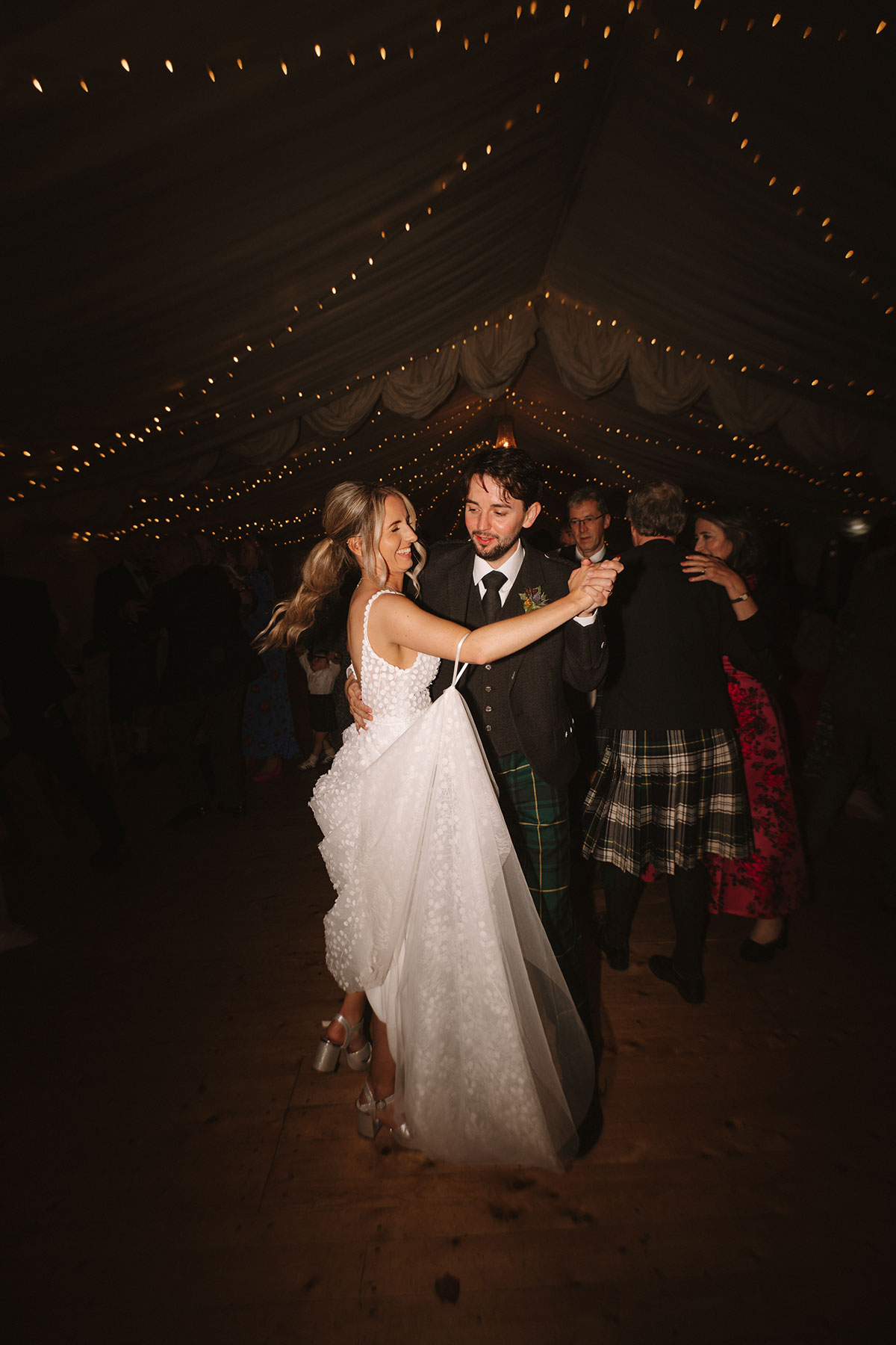 Flash photograph of the bride and groom dancing