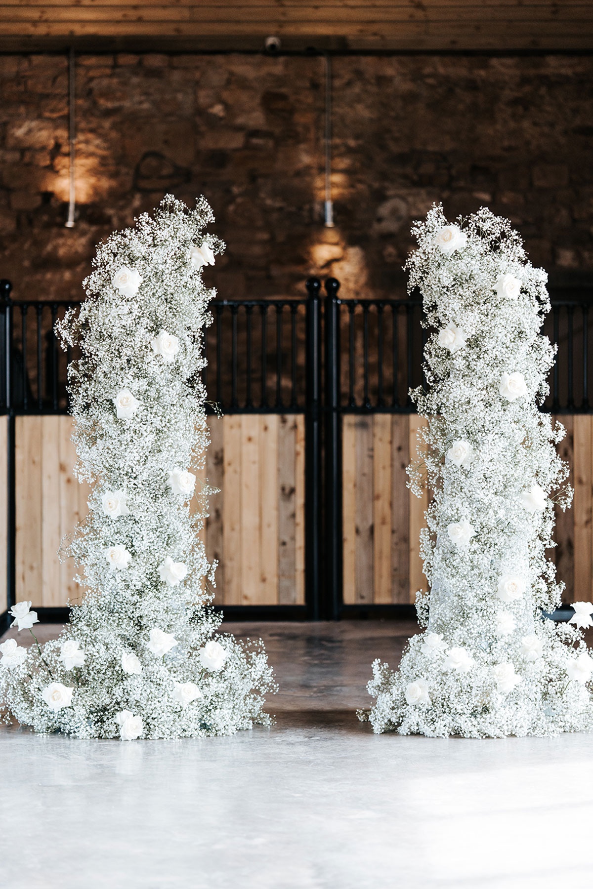 White rose and gypsophila aisle flowers for a rustic barn wedding ceremony in Scotland