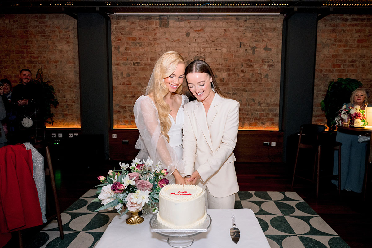 Brides cutting wedding cake at The Exchange Glasgow.