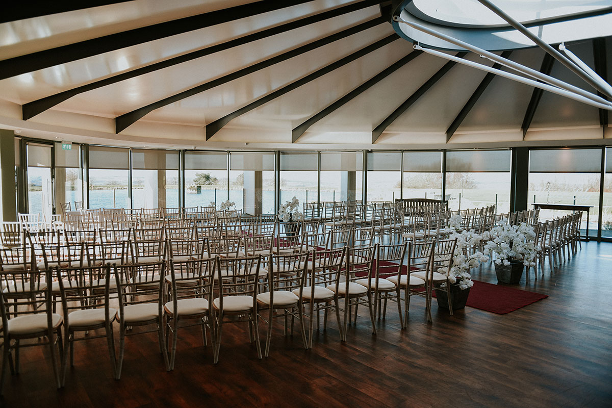 Wedding ceremony set-up inside The Vu’s Waterlily Suite with reservoir views in West Lothian