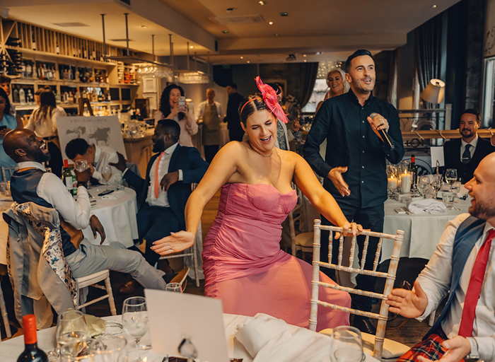 female guest in pink dress dancing