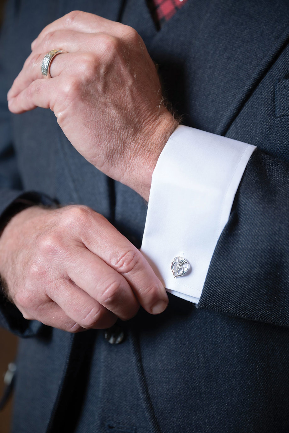 thistle cufflinks on a white shirt cuff