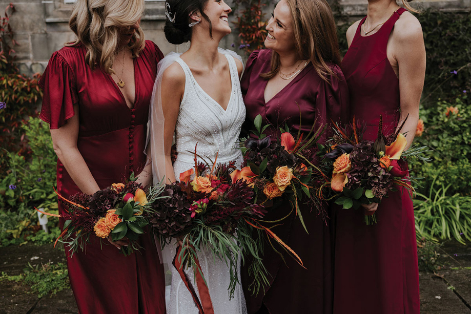 Bride And Bridesmaids Holding Autumnal Bridal Bouquets