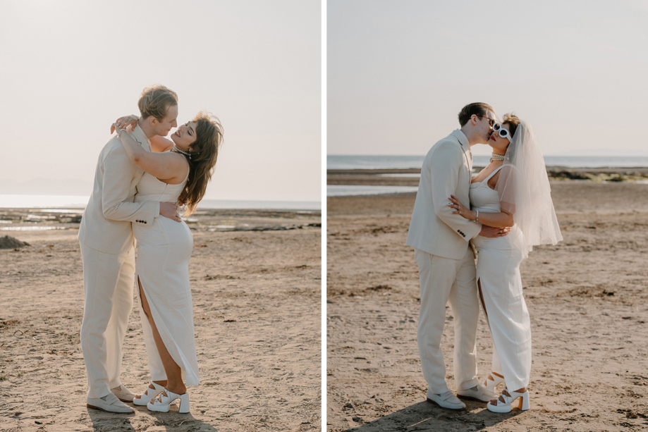 Couple portraits of the bride and groom embracing on a beach