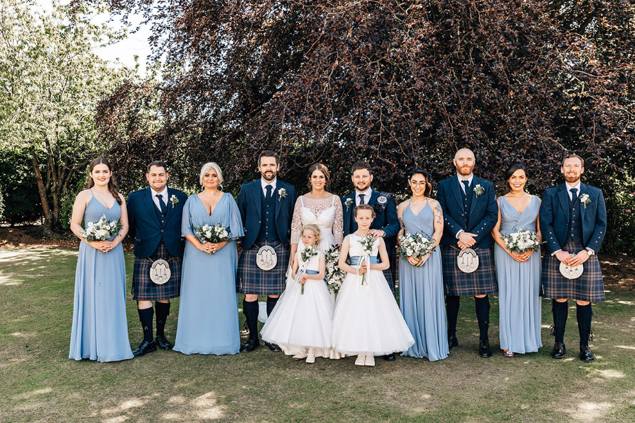 Group photo of bride and groom with their bridesmaids, groomsmen and flower girls