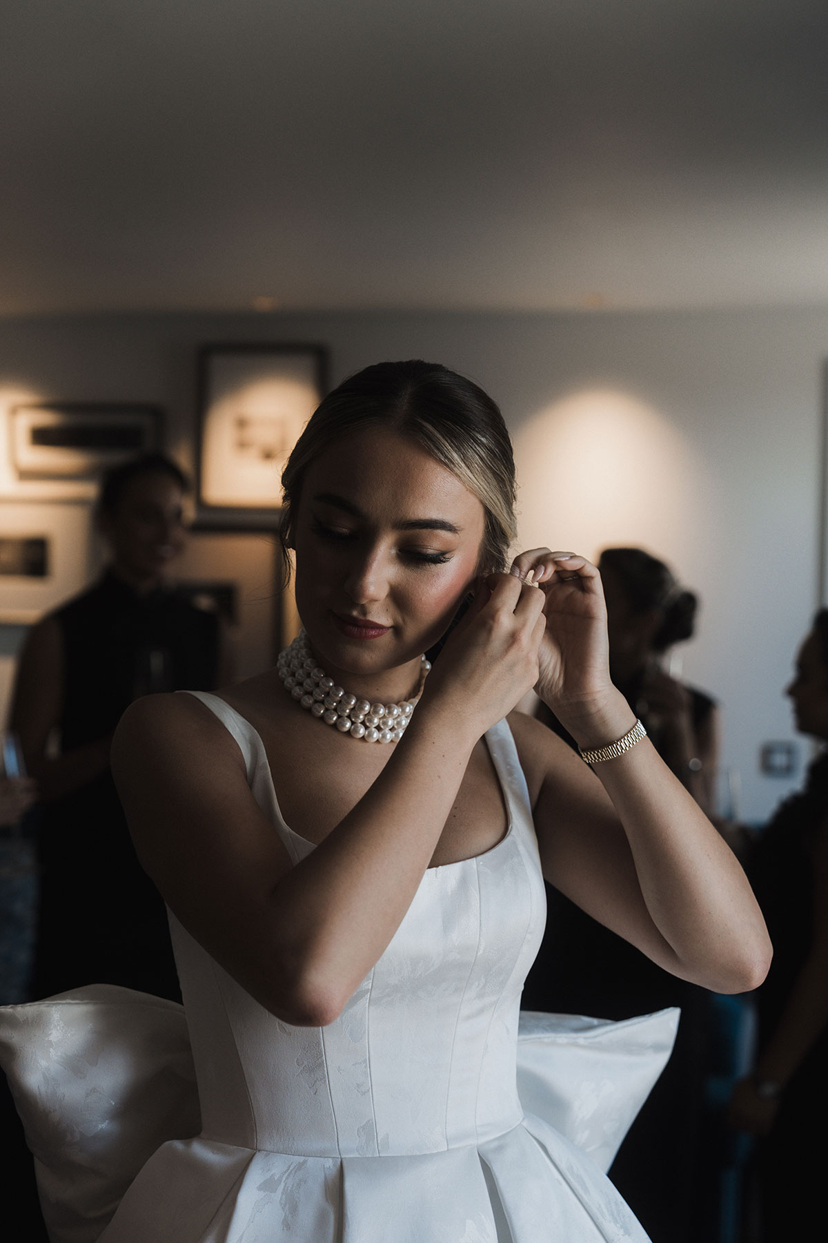  Bride fastening her earring while getting ready for Mansfield Traquair wedding