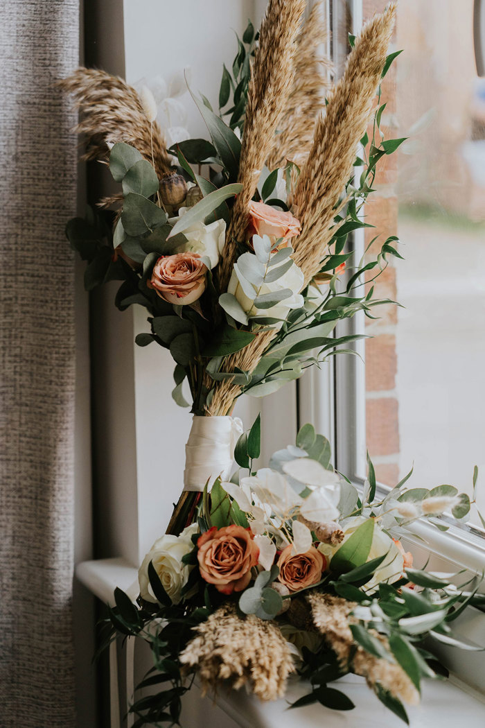 A bouquet of flowers in a window.