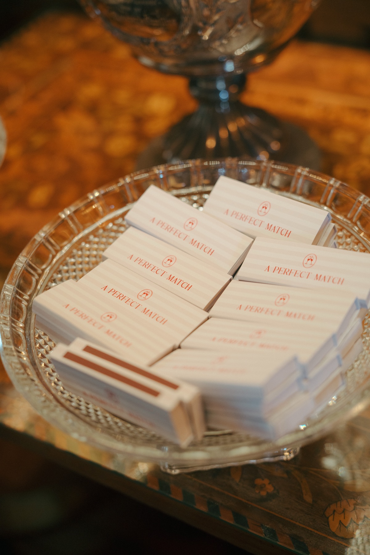 Personalised wedding matchbox favours reading 'A Perfect Match' displayed in a glass dish at Nicole and Ryan's Barnbougle Castle wedding.