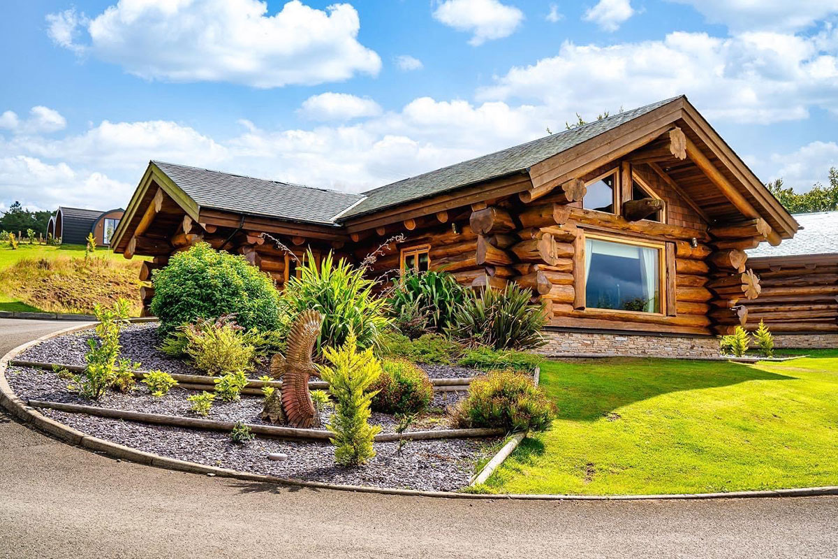 Exterior of one of The Vu’s Canadian log cabins, used as honeymoon accommodation for newlyweds