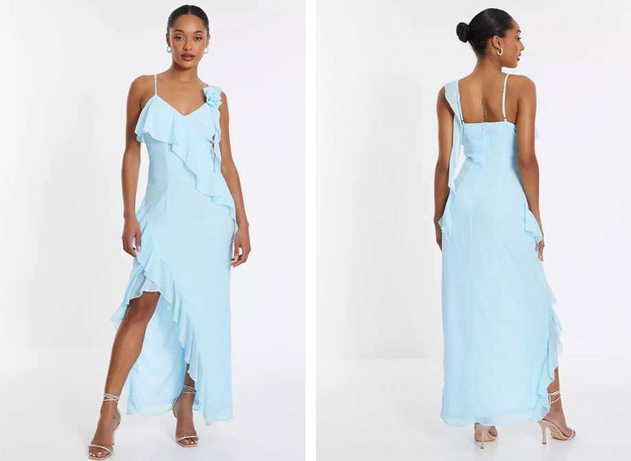 A woman wearing a light blue chiffon dress with thin straps and an a-symmetrical skirt